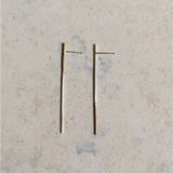 Mismatched silver and bras earrings , statement  thin silver earrings